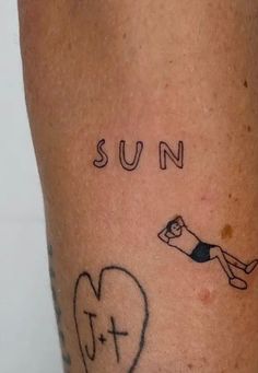 a person has a tattoo on their leg that says sun and a heart with a man diving into it