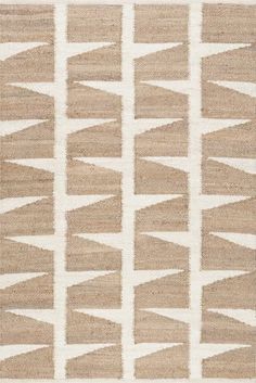 a beige and white rug with an abstract design