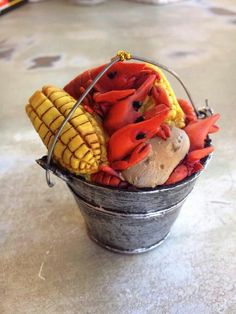 a bucket filled with corn and crab on the cob