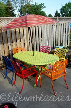 an outdoor table and chairs are painted bright colors