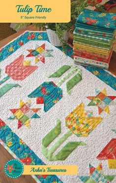 a table top with many different quilts on it and the title tulip time 5 - square friendly