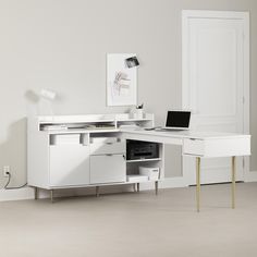 a white desk with a laptop on it