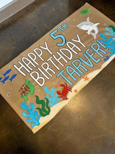 a sign that says happy 5th birthday with sea animals on it