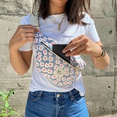 a woman holding a cell phone in her purse