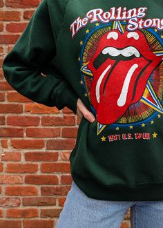 START ME UP! Soft, slouchy raglan crew sweatshirt featuring colorful Rolling Stones US Tour 1981 graphics at front. Lightweight (not bulky) with a classic fuzzy lining inside. Vintage hunter green colorway. Features: Slouchy, relaxed fit sweatshirt Crew neckline Long raglan sleeves Ribbed cuffs on sleeve Banded hem Colorful Rolling Stones graphics at front Hunter green colorway Lightweight with fuzzy lining inside Officially licensed Ethically made in California Brand & Fabric Content: Brand: Da Ankle Length Skirt, Ragged Priest, Nine Lives, Skirt Jumpsuit, Sock Gifts, Workout Sweatshirt, Girl Bands, Crew Sweatshirts, Dress Pant