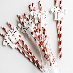 paper straws with red and white stripes are arranged in the shape of animals on them