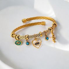 ❖Evil Eye Nazar Bracelet, Gold And Silver Bangle, Turkish Blue Eye Bracelet❖ What Is Included: 1x Evil Eye Bracelet Gold or Silver plated bracelet featuring intricate evil eye and heart charms, the perfect gift for a friend or loved one.  High Quality Stainless Steel Material  Gold or Silver Plated Design 30 Day Money Back Guarantee  At EyeSpyEvilEye, our family has dedicated over 4 years to designing and crafting quality products. Your support means the world to us as we continue to pursue our Metal Evil Eye Bangle Bracelet Gift, Blue Eye Bracelet, Nazar Bracelet, Silver Plated Bracelet, Blue Eye, Bracelet Sterling Silver, Eye Bracelet, Silver Bangle, Evil Eye Bracelet