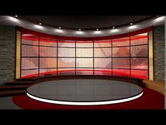 an empty television studio with red lighting on the wall and round table in front of it