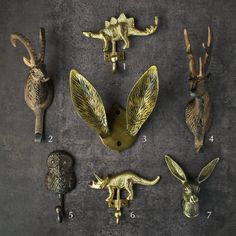 several different types of animal head hooks on a gray surface with numbers in the middle