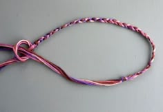 a pink and purple cord with a knot on it