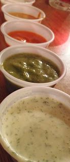 several bowls of soup are lined up on a table