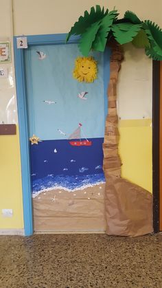 a door decorated to look like a beach scene with a palm tree and boat on the water