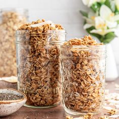 three jars filled with granola sitting on top of a table