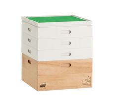 three wooden boxes stacked on top of each other, one with green lid and the other white