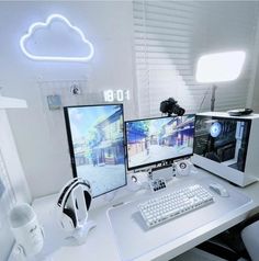 two computer monitors sitting on top of a white desk