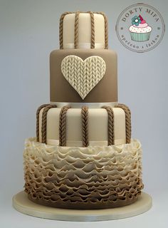 a three tiered cake decorated with hearts and braiding on the top is shown