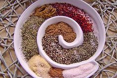 a white bowl filled with different types of spices