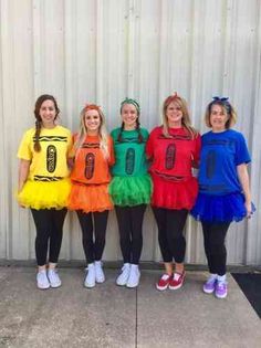 four girls in costumes standing next to each other