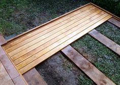 a wooden bench sitting on top of a lush green field