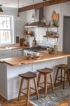 a kitchen with two stools and an island