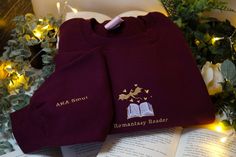 Romantasy Reader embroidered on the front of the jumper and AKA Smut written on the sleeve. If you would like the design WITHOUT the sleeve embroidery, please leave a note at the checkout. The jumper will automatically come with the "AKA Smut" on the sleeve unless a note is left. The sleeve embroidery is on the right Inside sleeve, so is quite discreet.  3XL-5XL only available in Navy, Speckle Grey, Pink, Burgundy, Black and White *Pink and Burgundy have different measurements, see separate size Embroidered Jumper, Pink And Burgundy, Sleeve Embroidery, Black And White Fabric, Embroidered Sweatshirt, Embroidered Sweatshirts, White Fabric, Sweat Shirt, Gender Neutral