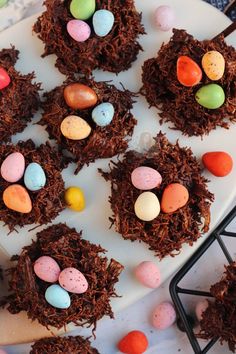 chocolate nests with candy eggs on a white plate