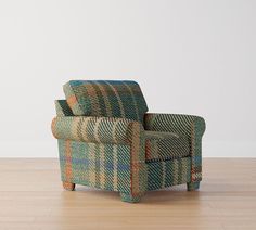 a chair sitting on top of a hard wood floor next to a white wall and wooden floors