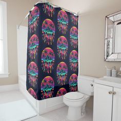 a bathroom with a shower curtain covered in colorful drips and an image of trees