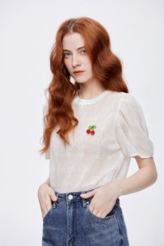 Play up summer’s best elements of a light and airy aesthetic with the Cherry Rhinestone Top. This semi-sheer white blouse brings understated glamor to any ensemble. The shirt’s demur nature is offset by the volume of the puffed sleeves. A button closure in the back gathers the neckline as the bottom of the top hangs comfortably. Pair with denim bottoms for a casual look or a midi skirt for a more dressed-up event. Details: Short sleeve cotton-blend semi-sheer tee in white featuring lace diamond White Feminine Blouse With Sheer Sleeves, White Puff Sleeve Top With Sheer Sleeves, White Sheer Short Sleeve Blouse, White Short Sleeve Blouse With Sheer Sleeves, White Blouse With Sheer Short Sleeves, Summer White Blouse With Sheer Sleeves, Elegant Puff Sleeve Summer Blouse, Elegant Summer Puff Sleeve Tops, Feminine Blouson Sleeve Tops For Summer