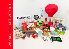 a table topped with lots of assorted items next to a red paper hot air balloon