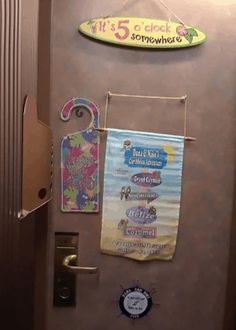 there is a surfboard hanging on the wall next to the door with magnets