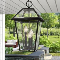 an outdoor hanging lantern with three lights on it