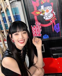 a woman posing in front of a vending machine