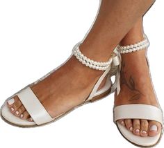 Cream Open Toe Lace-up Sandals For Beach, Elegant Beige Lace-up Sandals For Beach, Beige Adjustable Lace-up Open Toe Sandals, Cream Lace-up Sandals For Beach, Adjustable Beige Flat Lace-up Sandals, Cream Adjustable Ankle Strap Sandals, Cream Ankle Strap Lace-up Beach Sandals, Cream Ankle Strap Lace-up Sandals For Beach, Elegant Minimalism