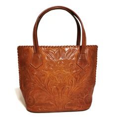 WOMEN'S BAG  Featuring a gorgeous chiseled design, this rustic TOOLED LEATHER Purse will help you bring a little VINTAGE flair to your everyday outfit. The perfect size for fitting all of your everyday essentials, this purse was actually HANDMADE with help of  talented Mexican artisans , giving it a rustic touch that's hard to find in stores.  The perfect choice as a gift for her!! ( Birthday, Christmas gift, Mothers day, etc.) CRAFTED FROM GENUINE COWHIDE LEATHER and best for casual and everyda Vintage Embossed Tote Bag, Luxury Brown Engraved Bags, Engraved Satchel Bag For Everyday Use, Vintage Hand Tooled Top Handle Bag, Engraved Satchel For Everyday Use, Everyday Engraved Satchel Bag, Brown Engraved Shoulder Bag For Everyday Use, Engraved Brown Shoulder Bag For Everyday Use, Brown Engraved Bags For Everyday Use