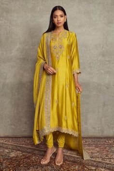 Mustard kurta with floral embroidery and scallop border. Paired with churidar and embroidered border dupatta.
Component: 3
Pattern: Embroidered
Type Of Work: Floral
Neckline: Notched
Sleeve Type: Long Sleeves
Fabric: Cheniya Silk
Color: Yellow
Other Details: 
Floral motifs
Embroidered border dupatta
Occasion: Wedding, Bride - Aza Fashions Trouser Pattern, Jayanti Reddy, Garden Embroidery, Zardozi Embroidery, Women Kurta, Kurta Set For Women, Orange Ombre, Embroidered Pants, Tarun Tahiliani