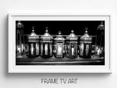 a black and white photo of some old fashioned lamps in front of a wall with the words frame tv art above it