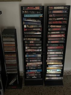 two tall black shelves filled with dvd's