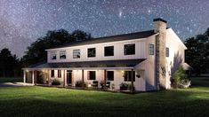 a white house sitting on top of a lush green field under a night sky filled with stars