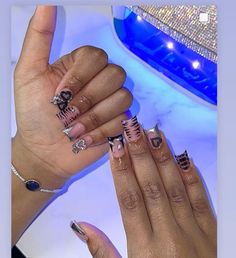 two hands with different nail designs on them