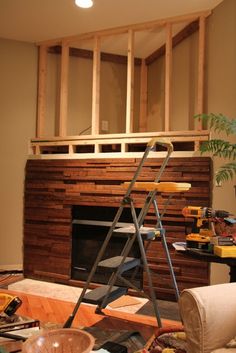 a living room filled with furniture and a fire place next to a wall mounted tv