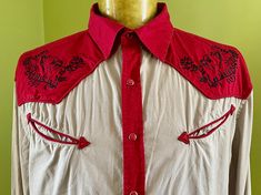 A super fun vintage cowboy shirt. A long sleeve shirt in beige with contrasting red yokes, cuffs and front button placket. The shirt has classic western details such as peaked front and back yokes, snap button closure and arrowed 'smile' pockets. The chest is also embroidered in black with florals and a chihuahua head. Size XX Large Measurements: Chest: 127 cm / 50 inches Shoulder: 52 cm / 20.5 inches Length: 79 cm / 31 inches Sleeve: 68.5 cm / 27 inches 96% Cotton, 4% Elastane This item is one of a kind. BUYING VINTAGE: While all care is taken to state any obvious faults, please note that when you buy a vintage or preloved item, they may show small signs of ageing, wear and/or repair. Visit my website   https://phoenixmenswear.com.au/ Lots of fun stuff for guys and girls...!! Red Western Style Tops For Ranch, Vintage Red Tops For Rodeo, Red Top For Summer Rodeo, Red Summer Top For Rodeo, Western Red Tops For Spring, Western Style Red Tops For Spring, Spring Western Red Tops, Cowboy Vintage, Vest Patches