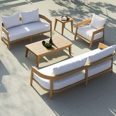 a group of wooden furniture sitting on top of a cement floor