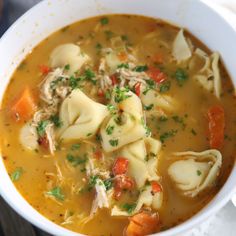 a bowl of soup with dumplings and carrots