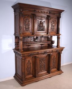 an old wooden cabinet with carvings on it