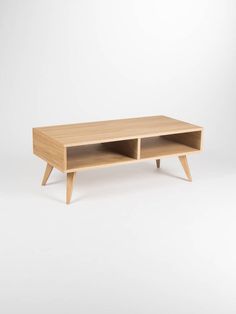 a wooden coffee table with two open shelves