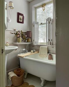 a white bath tub sitting next to a window