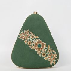 Elevate your evening ensemble with our "Enchanted Forest" Egg-Shaped Velvet Clutch, a masterpiece of artistry and elegance. Crafted from luxurious bottle green velvet, this clutch is a symphony of texture and color. The intricate embroidery, expertly done with onyx, garnet, and tiger eye gemstones, forms a mesmerizing pattern reminiscent of an enchanted forest. Size(cm): 20*18*4 Material: Velvet Fabric & Metal Thread Stones: Onyx, Garnet & Tiger Eye Base Color: Bottle Green Pockets: Single Each gemstone is carefully chosen not only for its aesthetic appeal but also for its unique energy and symbolism. The black onyx represents protection and strength, while the fiery red garnet symbolizes love and passion. Tiger eye adds a touch of grounding and confidence to the mix. The clutch's egg shap Formal Floral Embroidered Fabric, Formal Bollywood Style Embroidered Fabric, Elegant Hand Embellished Embroidered Fabric For Festive Season, Elegant Hand Embellished Embroidered Fabric For Festive, Elegant Hand-embellished Embroidered Fabric For Festive, Elegant Embellished Embroidered Fabric For Diwali, Festive Floral Embroidered Fabric For Formal Occasion, Elegant Embroidered Fabric For Navratri Party, Formal Festive Embroidered Fabric With Floral Embroidery