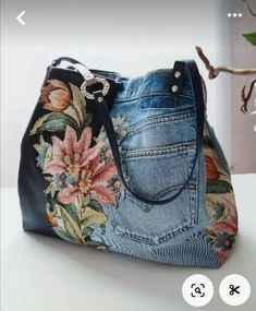 a handbag made out of jeans with flowers on it