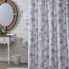 a bathroom with a sink, mirror and shower curtain